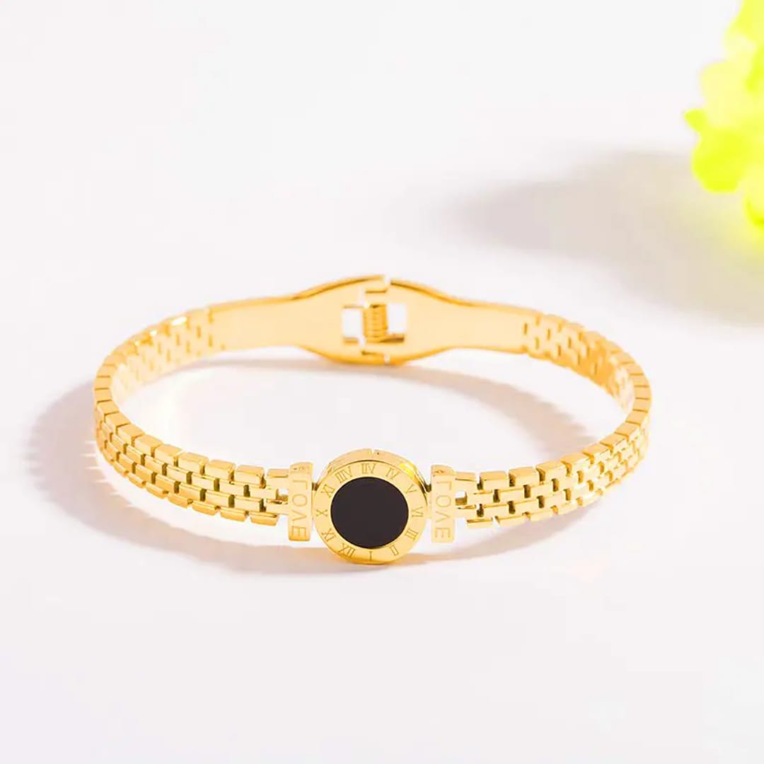 Gold bracelet with black center disk