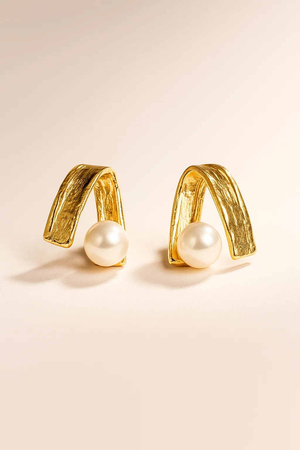 Modern textured gold earrings with pearl